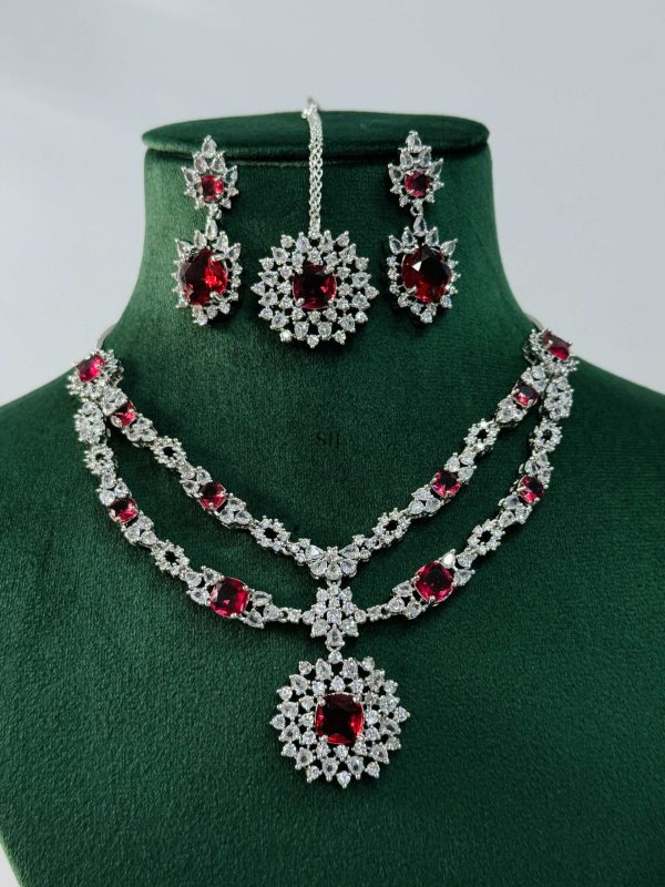 Silver Plated Flower Design Red Stone AD Necklace With Earrings And Maang Tikka